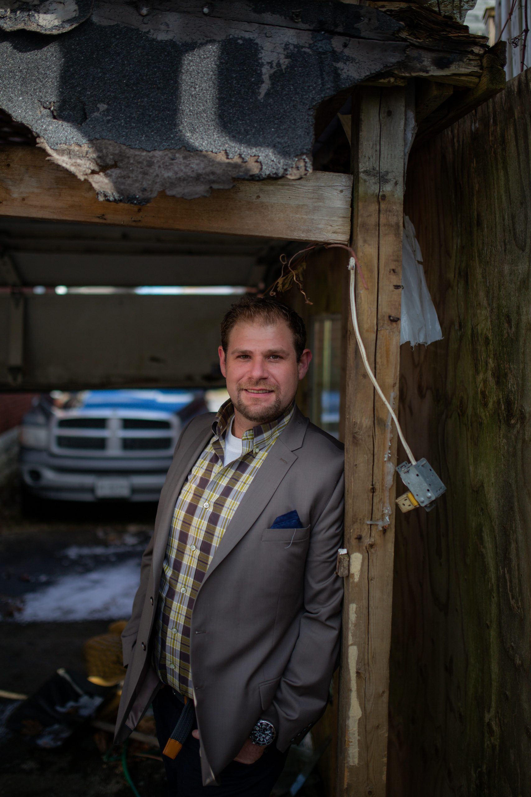 Matt Scott Private Cash Home Buyer Real Estate Investor leaning the wall of a demolished house before fixing and flipping